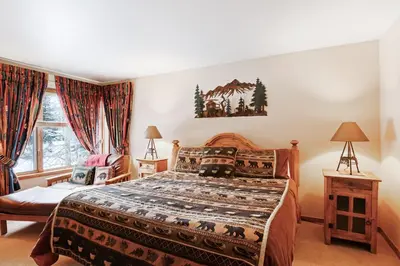 a bedroom with a large bed and a window at Ski Run Condominiums #108 in Keystone