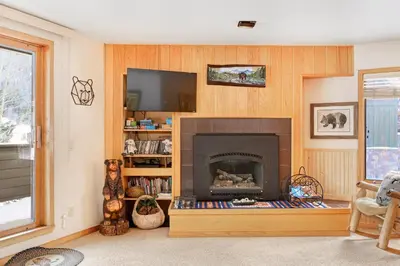 a living room with a fireplace and a tv at Ski Run Condominiums #108 in Keystone