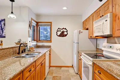 a kitchen with a sink and a refrigerator at Ski Run Condominiums #108 in Keystone