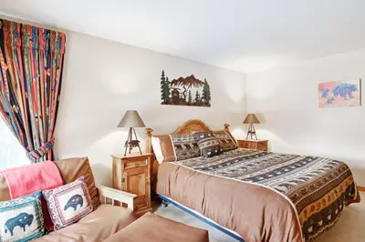 a bedroom with a bed and a couch at Ski Run Condominiums #108 in Keystone