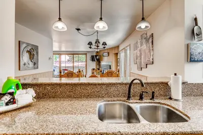 a kitchen with a sink and a living room at Ski Run Condominiums #108 in Keystone