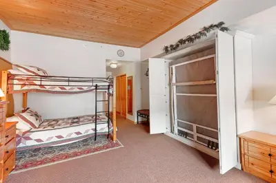 a bedroom with two bunk beds and a closet at Gateway #5055 in Keystone