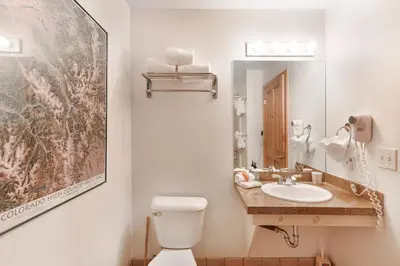 a bathroom with a sink and a toilet and a mirror at Gateway #5055 in Keystone