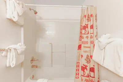 a bathroom with a tub and a shower curtain at Gateway #5055 in Keystone