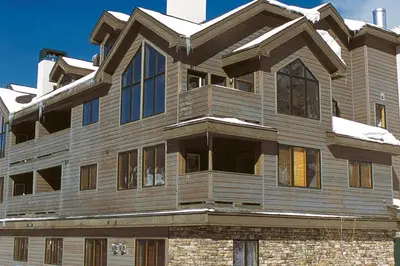 a large wooden house with snow on the roof at Gateway #5055 in Keystone