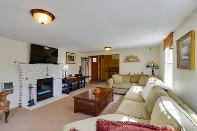 a living room with a couch and a fireplace at Empire Vacation Rental with Fire Pit and Gas Grill! in Empire