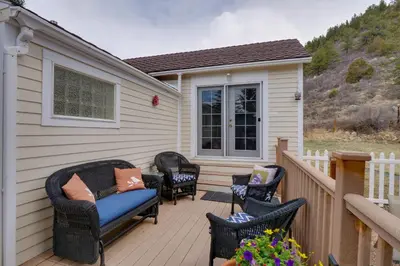 a patio with wicker chairs and a blue couch at Empire Vacation Rental with Fire Pit and Gas Grill! in Empire