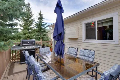 a patio with a table and chairs and an umbrella at Empire Vacation Rental with Fire Pit and Gas Grill! in Empire