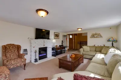 a living room with a couch and a fireplace at Empire Vacation Rental with Fire Pit and Gas Grill! in Empire