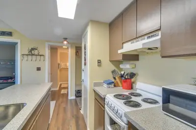 a kitchen with a stove and a counter top at 1 Mi to Granby Ranch Cozy Condo with Fireplace in Granby