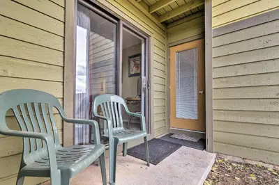 two chairs sitting on the front porch of a house at 1 Mi to Granby Ranch Cozy Condo with Fireplace in Granby
