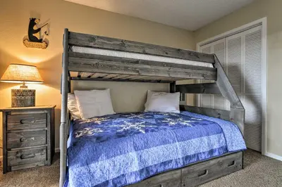 a bedroom with a wooden bunk bed and a lamp at 1 Mi to Granby Ranch Cozy Condo with Fireplace in Granby
