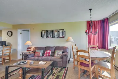 a living room with a couch and a table at 1 Mi to Granby Ranch Cozy Condo with Fireplace in Granby