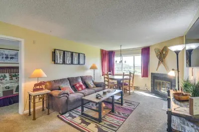 a living room with a couch and a table at 1 Mi to Granby Ranch Cozy Condo with Fireplace in Granby