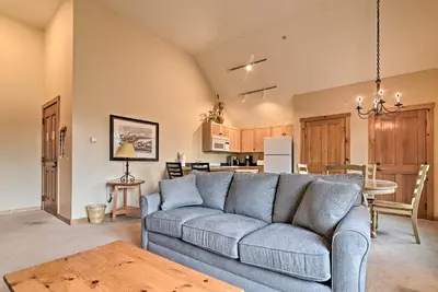 a living room with a couch and a kitchen at Keystone Ski Condo with Mtn View - Walk to Gondola! in Keystone