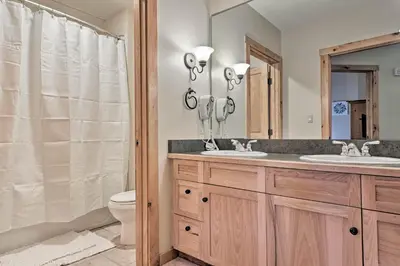 a bathroom with two sinks and a toilet at Keystone Ski Condo with Mtn View - Walk to Gondola! in Keystone