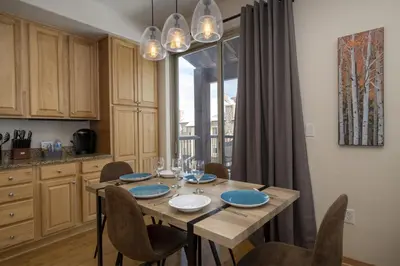 a dining room with a table and chairs and a window at Trailhead Lodge One Bedroom 801 condo in Winter Park