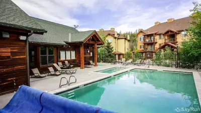 a swimming pool in front of a house at Trailhead Lodge One Bedroom 801 condo in Winter Park