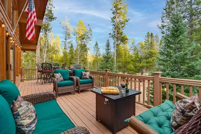 a deck with chairs and a table on a house at 2 Mi to Rocky Mountain Natl Park Cabin with Views in Grand Lake