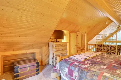 a bedroom with a bed in a wooden cabin at 2 Mi to Rocky Mountain Natl Park Cabin with Views in Grand Lake