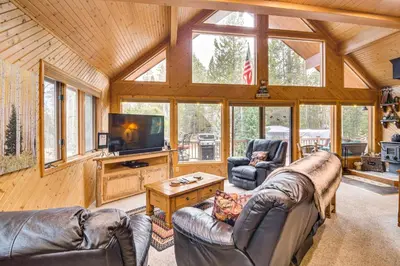 a living room with leather couches and a tv at 2 Mi to Rocky Mountain Natl Park Cabin with Views in Grand Lake