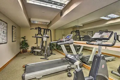 a gym with several tread machines in a room at Greenwood Village Condo with Pool Access! in Greenwood Village