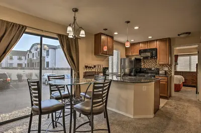 a kitchen with a table and chairs in a room at Greenwood Village Condo with Pool Access! in Greenwood Village