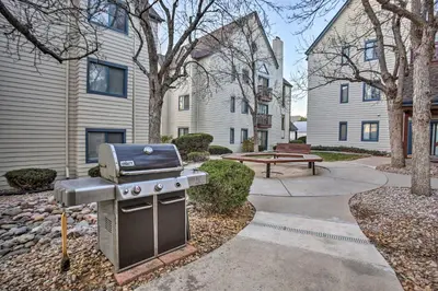 a barbecue grill in a yard in a courtyard at Greenwood Village Condo with Pool Access! in Greenwood Village