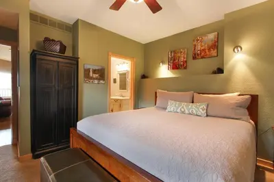a bedroom with a bed and a ceiling fan at Deer Mountain 28B condo in Estes Park