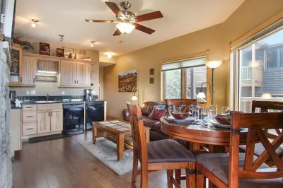 a kitchen and dining room with a table and chairs at Deer Mountain 28B condo in Estes Park