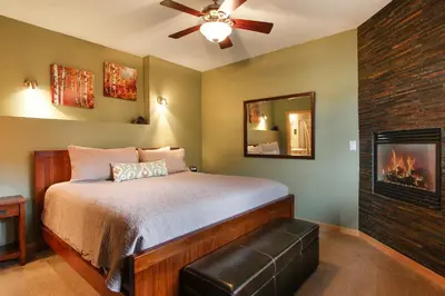 a bedroom with a bed and a fireplace at Deer Mountain 28B condo in Estes Park
