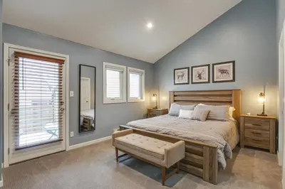 a bedroom with a large bed and two windows at Updated Townhome Near Main Street, 10 Mi to Breck! in Frisco