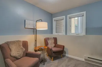a living room with two chairs and a lamp at Updated Townhome Near Main Street, 10 Mi to Breck! in Frisco