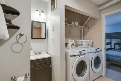 a laundry room with a washing machine and a sink at Updated Townhome Near Main Street, 10 Mi to Breck! in Frisco