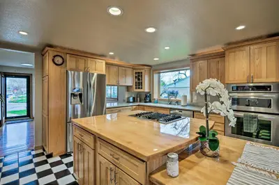 a kitchen with wooden cabinets and a wooden counter top at Arvada Home with Beautifully Landscaped Yard! in Arvada