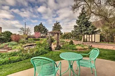 two chairs and a table in a garden at Arvada Home with Beautifully Landscaped Yard! in Arvada