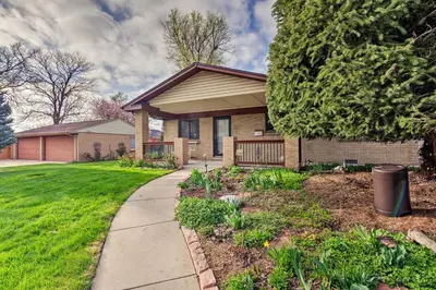 a house with a sidewalk in front of a yard at Arvada Home with Beautifully Landscaped Yard! in Arvada