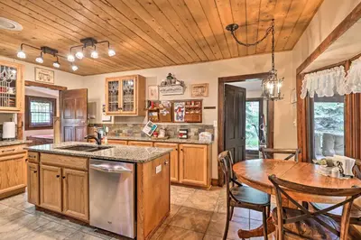 a kitchen with a table and a wooden ceiling at Family Home in Georgetown Walk to Town and Railroad in Georgetown