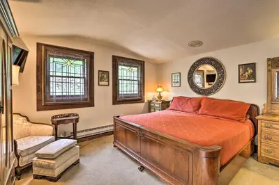 a bedroom with a bed and a chair and a mirror at Family Home in Georgetown Walk to Town and Railroad in Georgetown