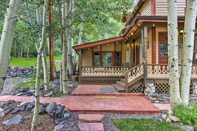 a home with a porch and stairs in the woods at Family Home in Georgetown Walk to Town and Railroad in Georgetown
