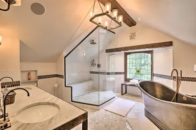 a bathroom with a tub and a glass shower at Family Home in Georgetown Walk to Town and Railroad in Georgetown