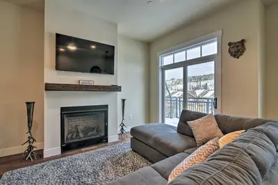 a living room with a couch and a fireplace at Modern Winter Park Ski Condo Near the Ski Shuttle! in Winter Park