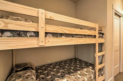 a bedroom with two bunk beds in a room at Modern Winter Park Ski Condo Near the Ski Shuttle! in Winter Park