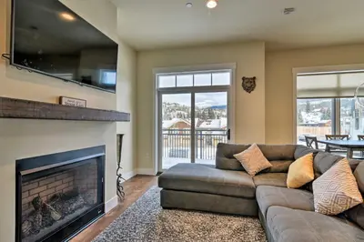 a living room with a couch and a fireplace at Modern Winter Park Ski Condo Near the Ski Shuttle! in Winter Park