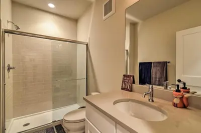 a bathroom with a toilet and a sink and a shower at Modern Winter Park Ski Condo Near the Ski Shuttle! in Winter Park