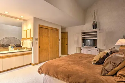 a large bedroom with a bed and a kitchen at Ski-InandSki-Out Winter Park Condo with Pool Access! in Winter Park