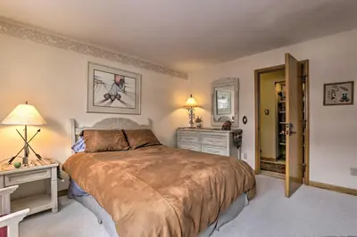 a bedroom with a large bed and two night stands at Ski-InandSki-Out Winter Park Condo with Pool Access! in Winter Park