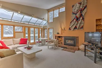 a living room with a couch and a fireplace at Ski-InandSki-Out Winter Park Condo with Pool Access! in Winter Park