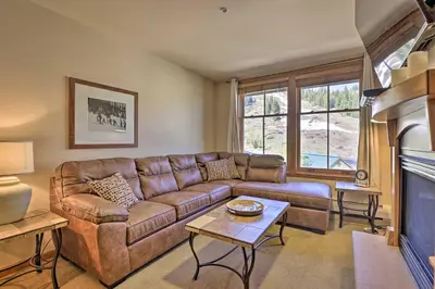 a living room with a couch and a fireplace at Cozy Ski-InandSki-Out Winter Park Resort Condo! in Winter Park