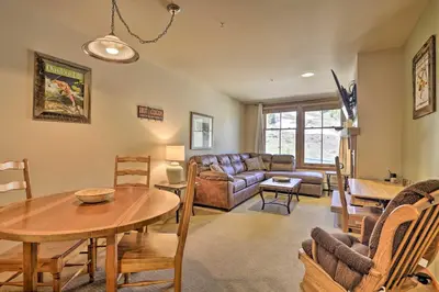 a living room with a couch and a table at Cozy Ski-InandSki-Out Winter Park Resort Condo! in Winter Park